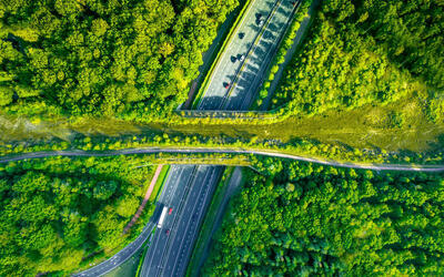 Aerial directly above view of a green bridge ecoduct for fauna crossing above highway in the Western Europe.