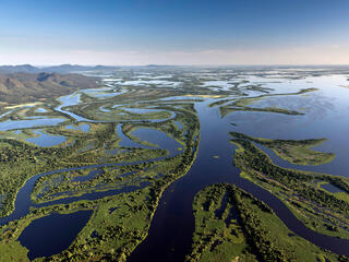 Aerial view of the Pantanal Matogrossense National Park with Amolar Mountain Ridge in the background. on a sunny day