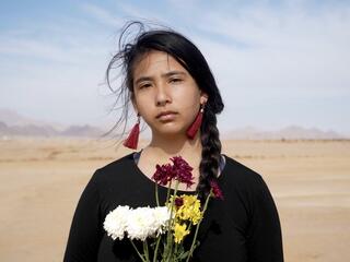 Alexia Leclercq looks at the camera while standing in the desert