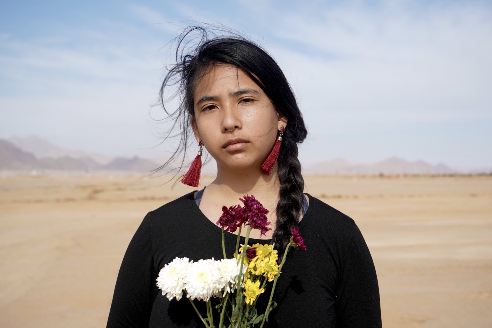 Alexia Leclercq looks at the camera while standing in the desert