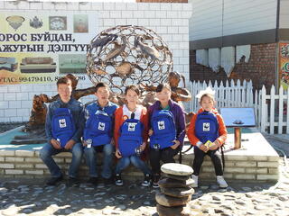 Student leaders pose in front of sculpture 