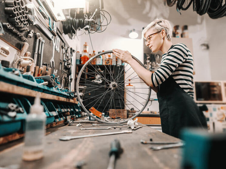 A person working on a bicycle wheel