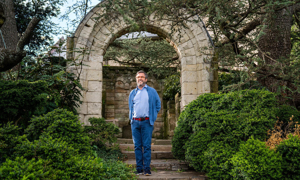 Moreno stands beneath a garden arch