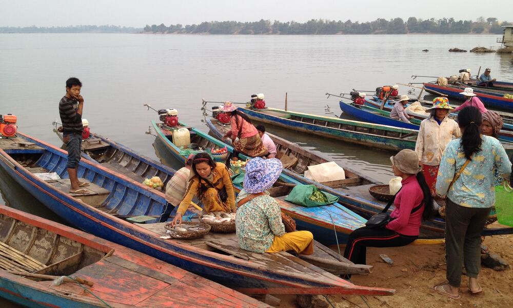 Villagers prepare for their day on beached boats.