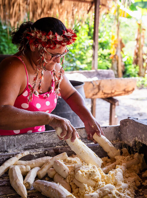 A woman prepares food outdoors