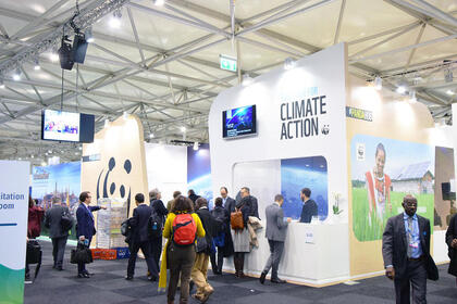 People walk around the Climate Action Center at COP 23