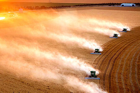 Aerial photo of multiple combines crossing a field
