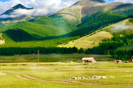 Landscape of farm with green mountains in background