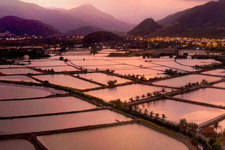 Sunset on rice fields below mountains