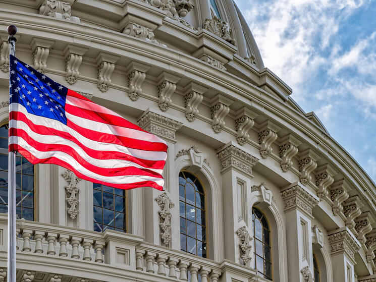 Washington DC Capitol dome detail with waving american flag