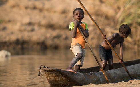 Children learn from a young age how to navigate the river - Luangwa River, Zambia