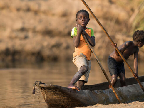 Children learn from a young age how to navigate the river - Luangwa River, Zambia