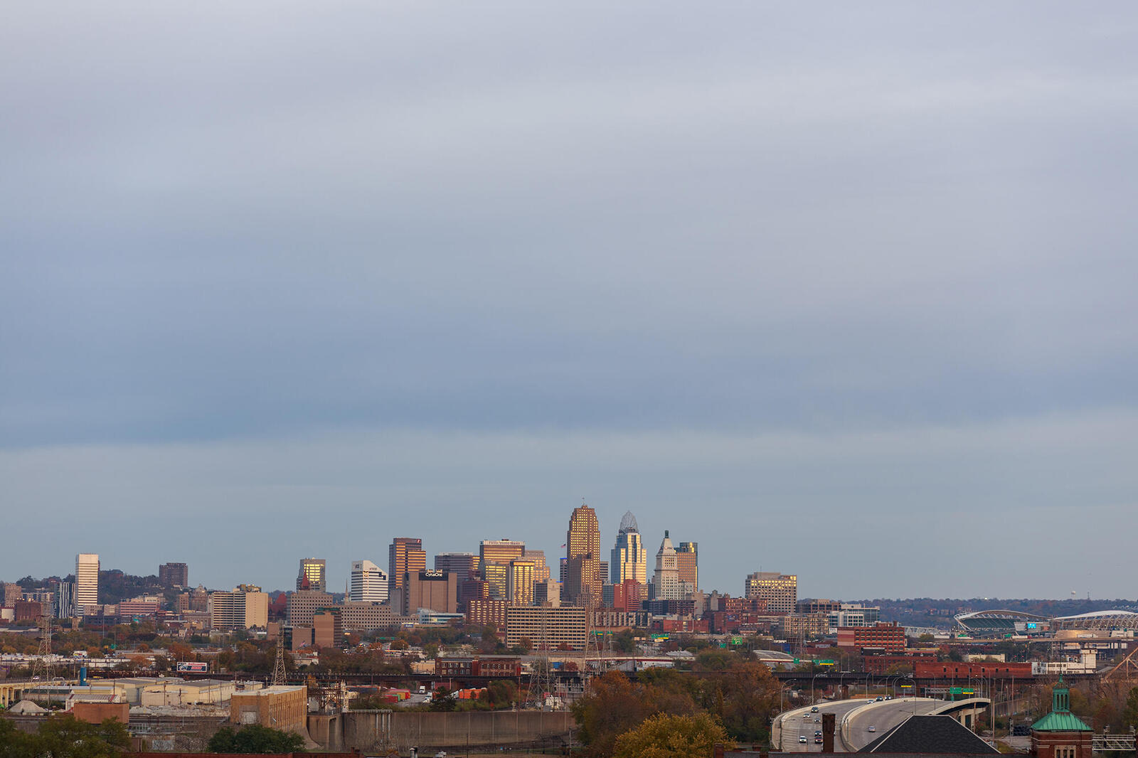 Skyline of the city of Cincinnati against a cloudy sky.