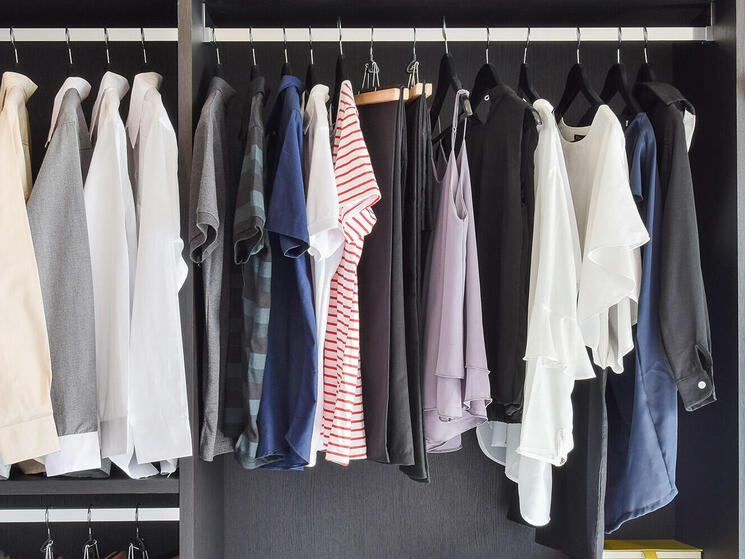modern closet with row of cloths hanging