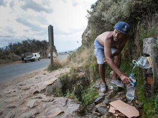 People coming from far and wide to collect water from Franschhoek spring in Cape Town, South Africa.