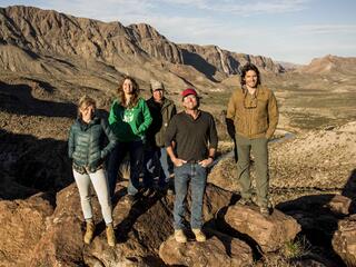 Nate and Morgan stand with WWF staff members above the Rio Grande.