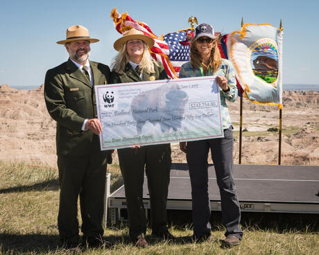 
Park rangers accept check from WWF