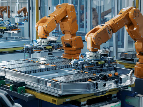 Orange robot arms assembling equipment