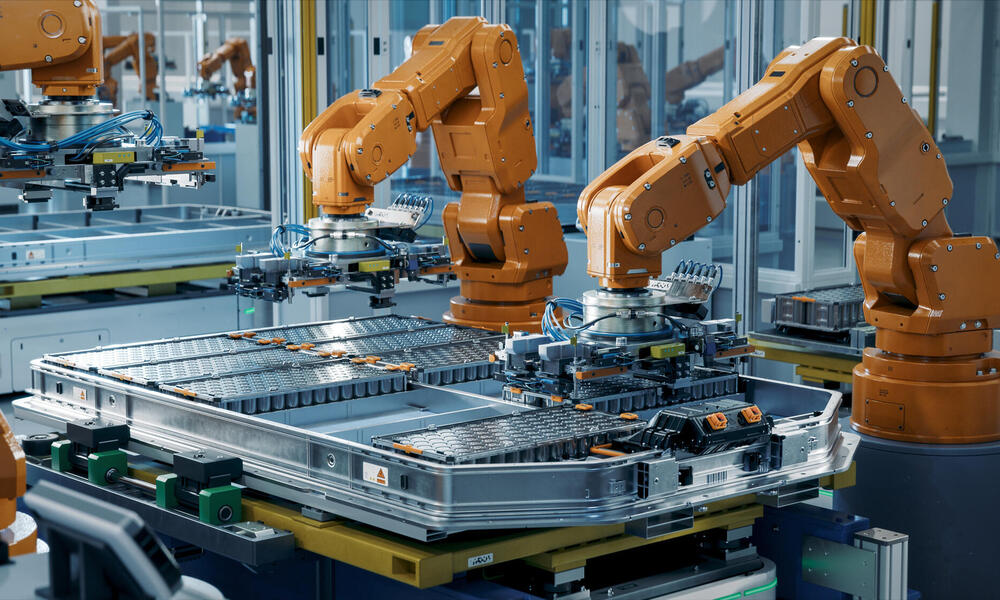 Orange robot arms assembling equipment
