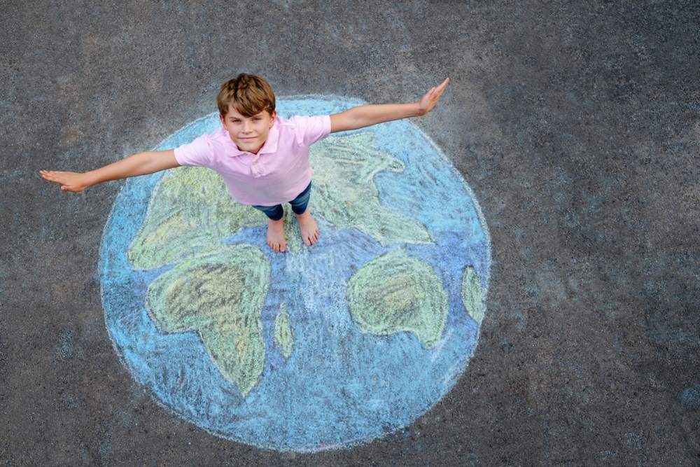 boy standing on chalk drawing of earth