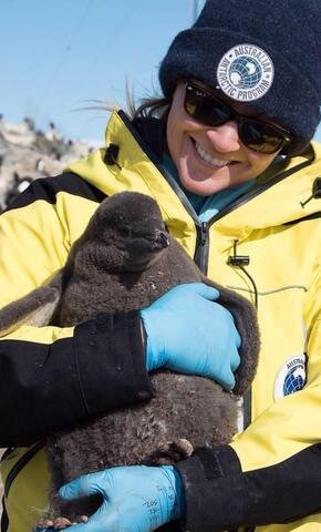 Emilt Grilly Holding  a Penguin