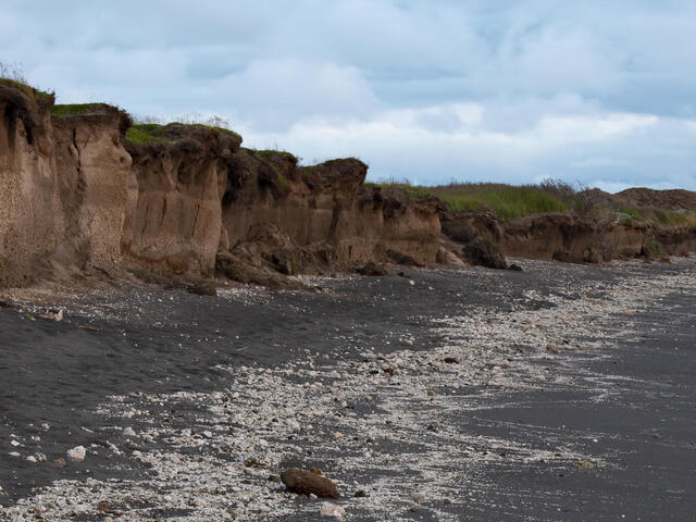 Eroding cliffs along the shoreline of Bristol Bay near the former village of Meshik. The village was completed relocated several miles inland due to coastal erosion in Port Heiden, Alaska, United States.