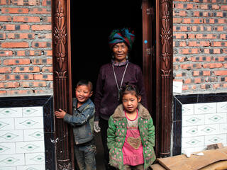 Family participates in energy efficient cookstove project in Liangshan, China