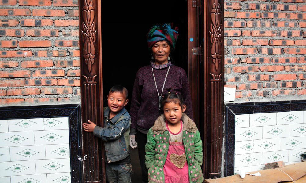Family participates in energy efficient cookstove project in Liangshan, China