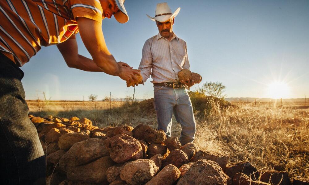 Farmers build a rock dam