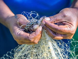 Hands holding a fishing net