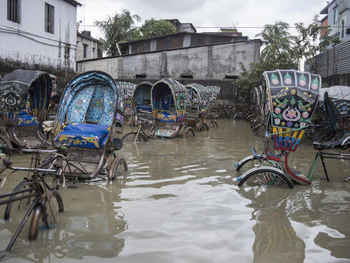 Rickshaws in tidal floodwater