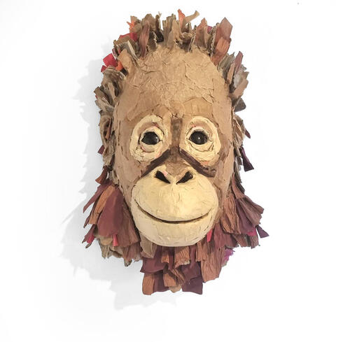 Cardboard and paper sculpture of baby orangutan head