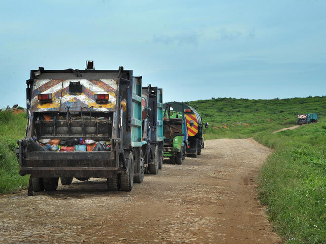 garbage trucks headed to landfill