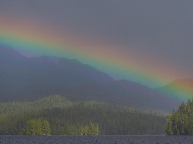 Rainbow encompassing the mountains and waters of Millbanke Sound, British Columbia, Canada