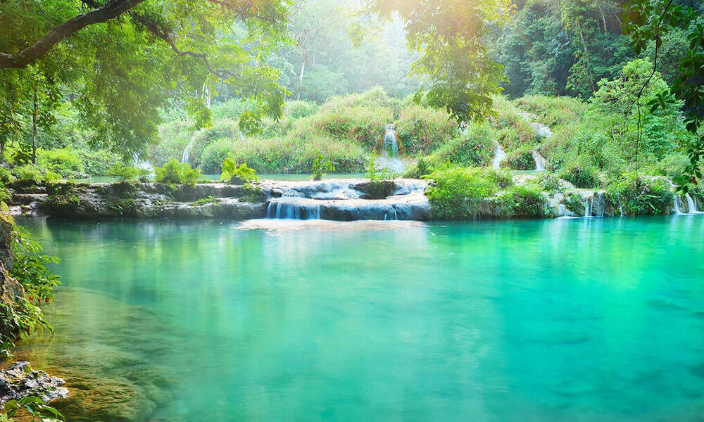 Clear turquoise river in a rain forest National Park in Guatemala Semuc Champey at sunset 