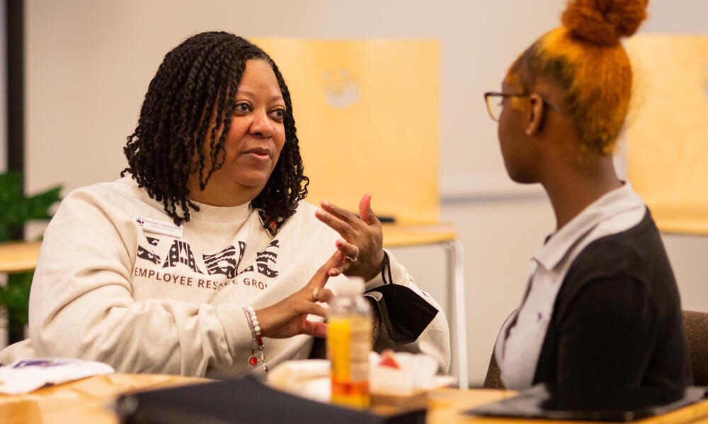 Renee Johnson, SVP of People and Culture, has a conversation with a student.