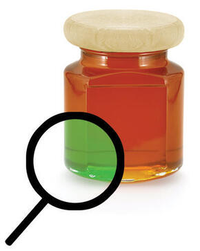 Bottle of honey with magnifying glass