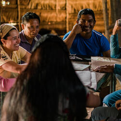 People smiling around a conference table