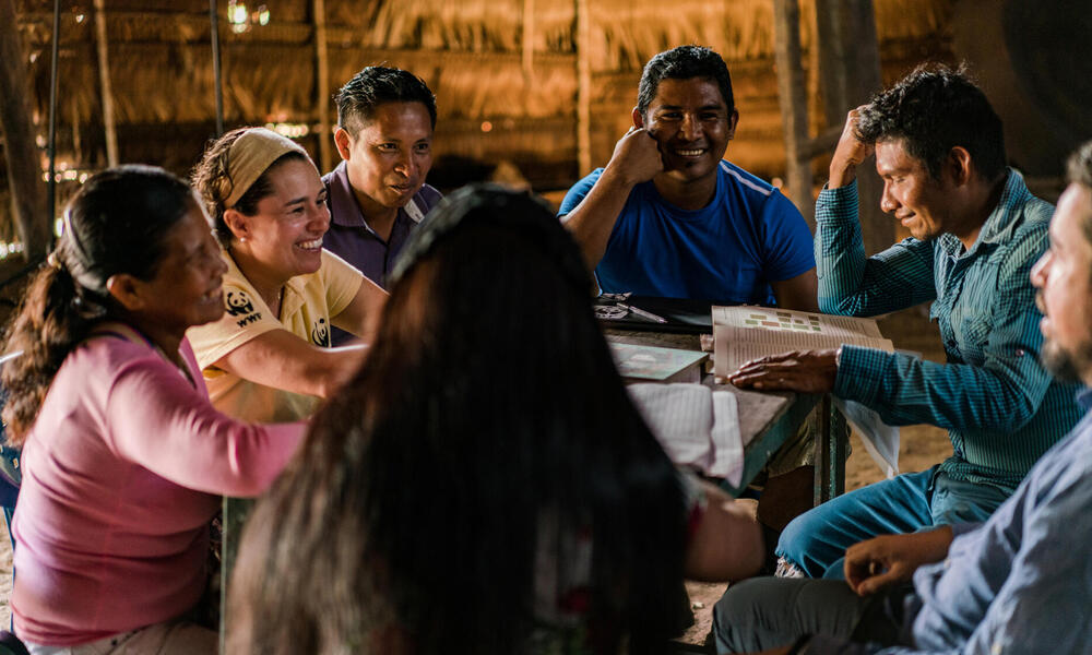 People smiling around a conference table