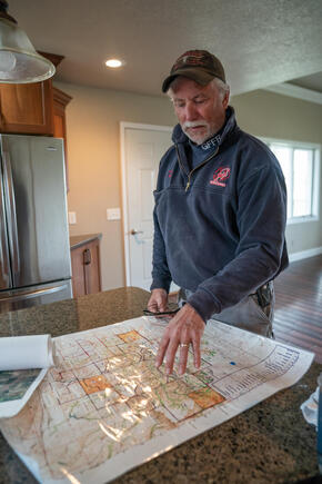 a man points to an area on a map