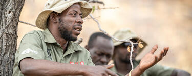 Lion Ranger Jendery Tsaneb sits under a tree and talks about human wildlife coexistence in Namibia