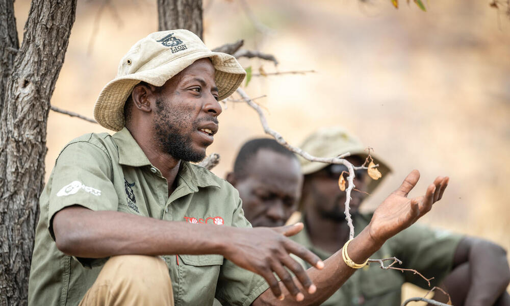 Lion Ranger Jendery Tsaneb sits under a tree and talks about human wildlife coexistence in Namibia