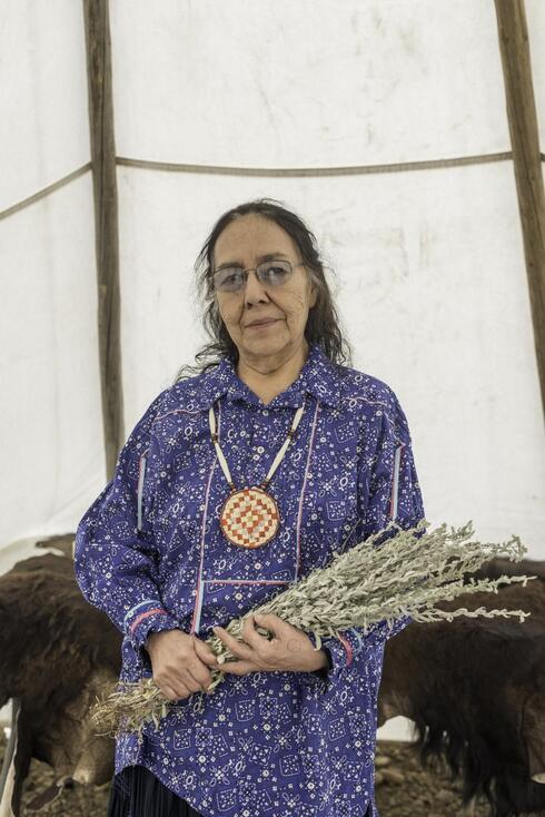 Lois Red Elk uses a bundle of sage as a prop when she performs one of the Sioux people’s sacred stories