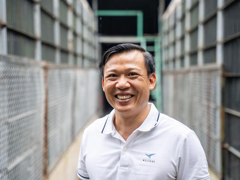 Luong Xuan Hong, Director of Ha Noi Wildlife Rescue Center located in Soc Son, Ha Noi, Viet Nam., wears a blue shirt and smiles at the camera