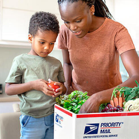 Woman and child open USPS box