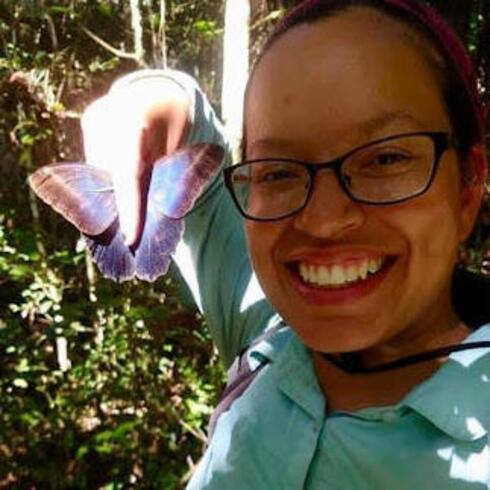 WWF scientist Mabel Baez Schon holds a buttefly specimen