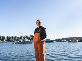 Seaweed farmer Karen Cooper stands on pier in Owls Head Harbor, Maine