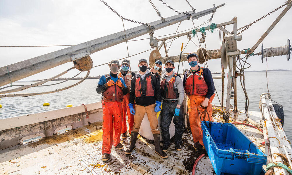 Kelp harvesting crew poses on boat