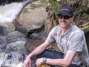 Matt Inbusch in front of a waterfall in the Atlantic Forest