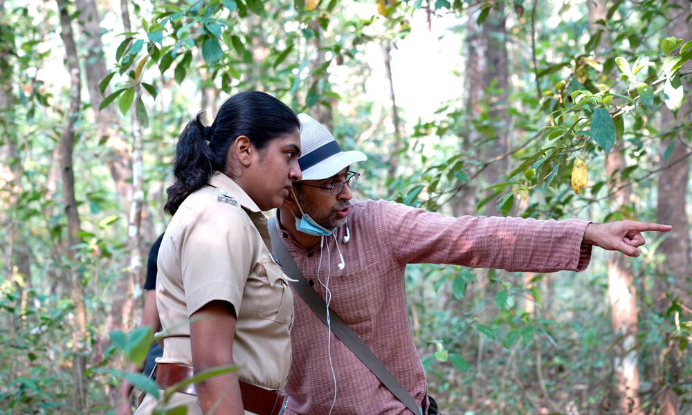 Two people talk closely in the forest 